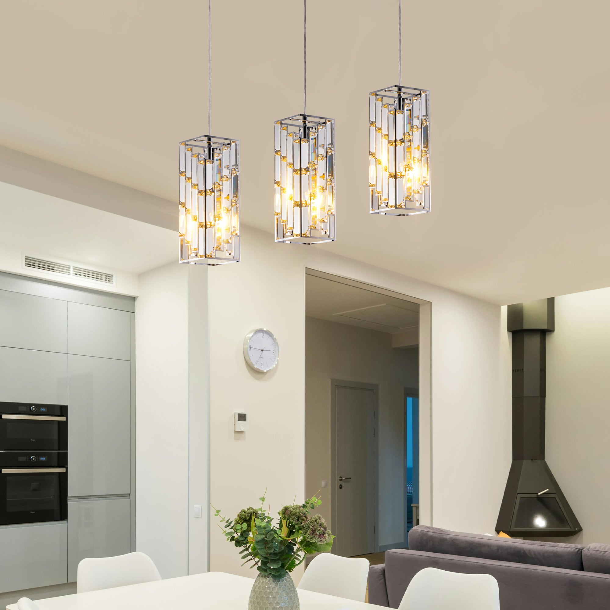 Chrome crystal pendant light set in modern dining room