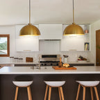 Copper dual-head pendant light hanging over dining table