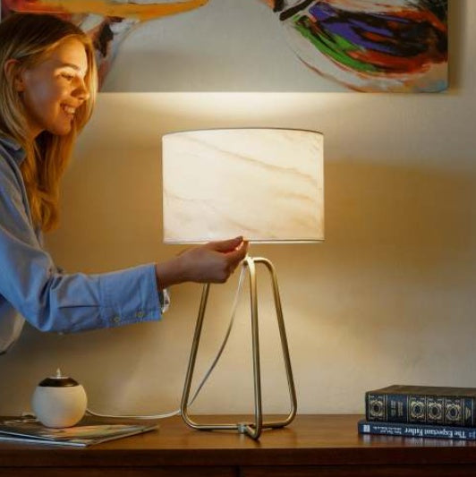Bronze metal base desk lamp with marble shade in bedroom setting