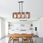 Wood and black metal farmhouse chandelier hanging over kitchen island