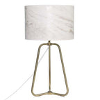 Stylish marble shade lamp glowing warmly on bedside table
