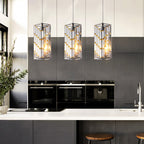 Three chrome crystal pendant lights hanging over kitchen island