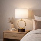Circular grid metal lamp shade close-up with warm white glow