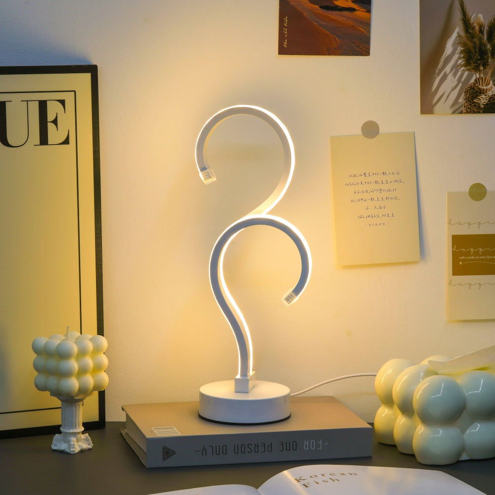Question mark shaped LED table lamp glowing in warm white