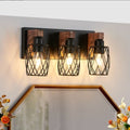 Vintage Edison bulb glowing in black cage wall sconce